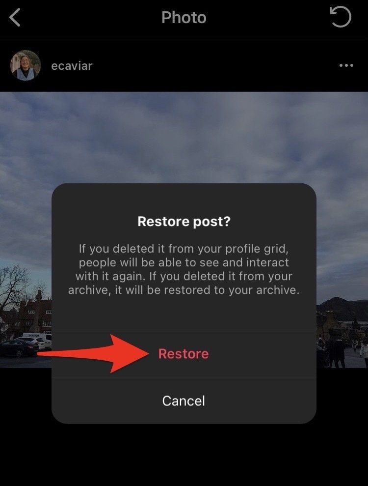 Screenshot of Instagram restore photo page with a red arrow pointing to "Restore."