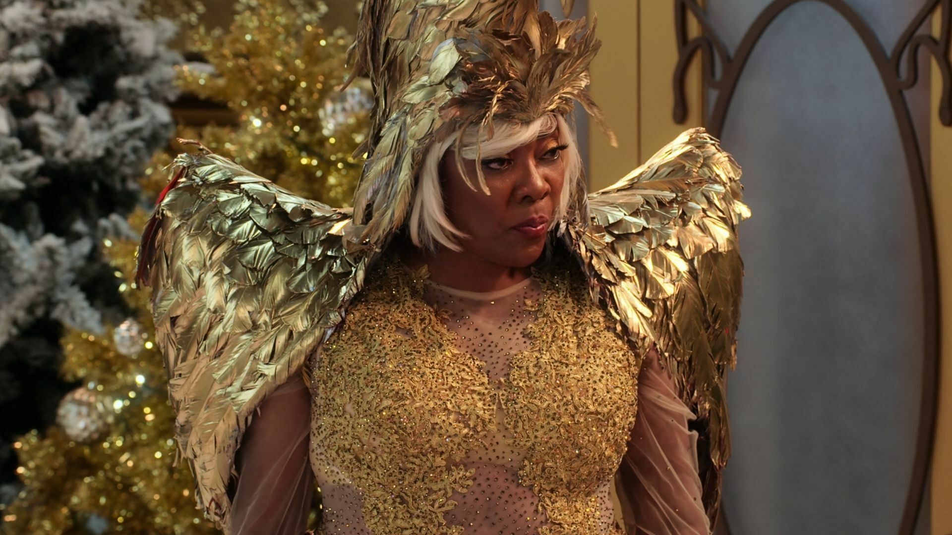 A Black woman in gold feathers and finery, from "Family Reunion"