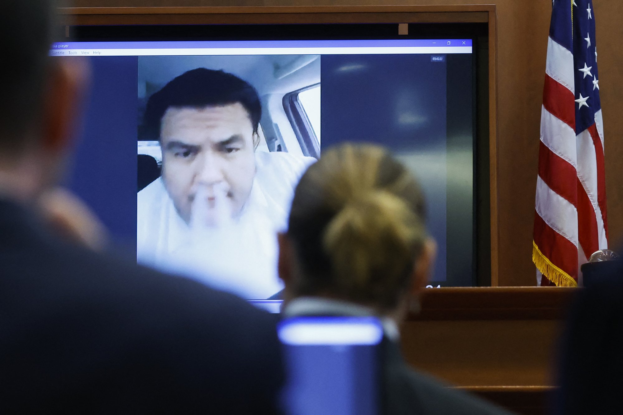 A photo of Romeros' pre-taped deposition as it is played for the court.