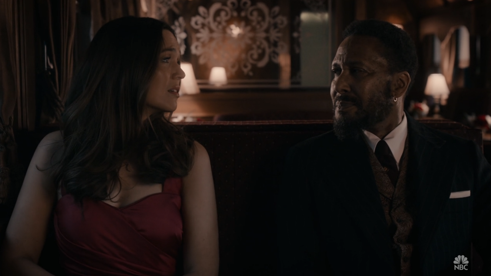 A woman (Mandy Moore) and a man (Ron Cephas Jones) sitting next to each other on a train.