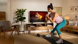 Woman following a workout on a TV