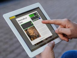 Finger poking at screen of tablet on language learning app