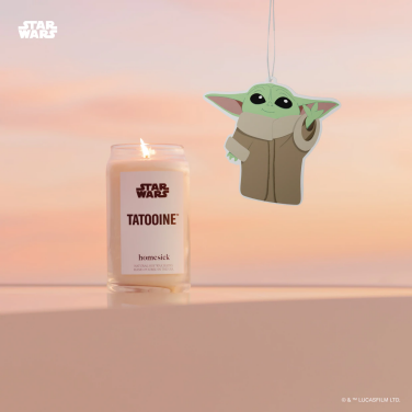 homesick's tatooine candle and grogu car fresher in front of a pastel gradient