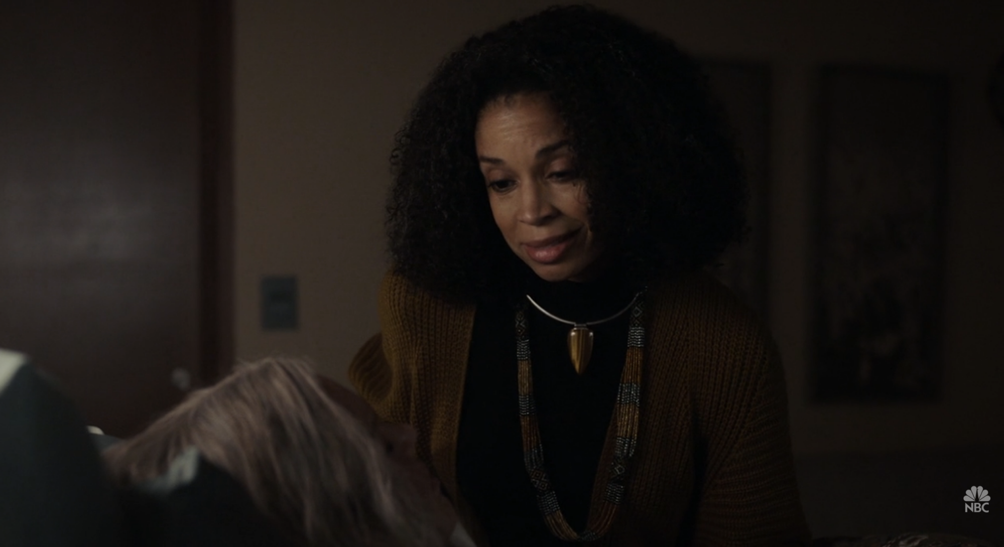 A woman (Susan Kelechi Watson) sitting on the bedside of another woman (Mandy Moore) and talking down to her.