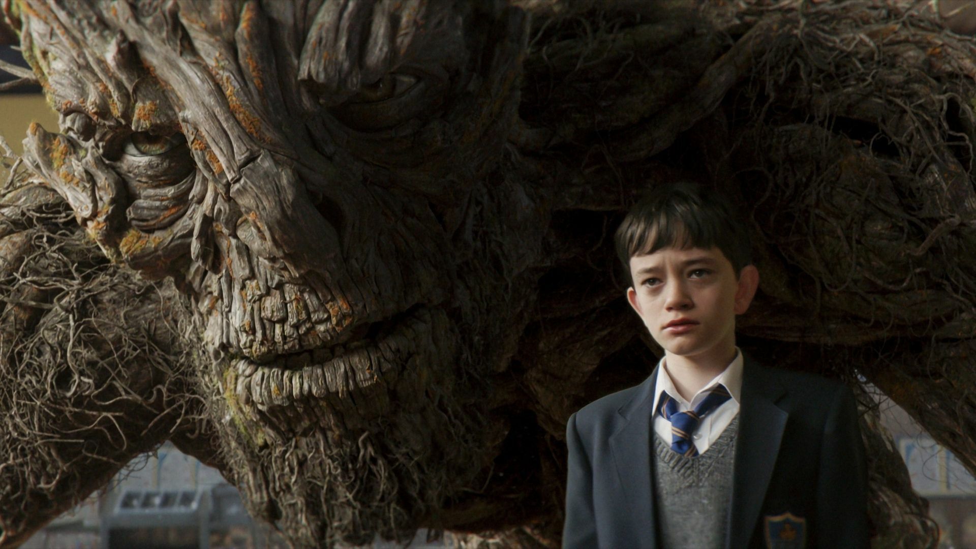A small boy with a large tree monster. 