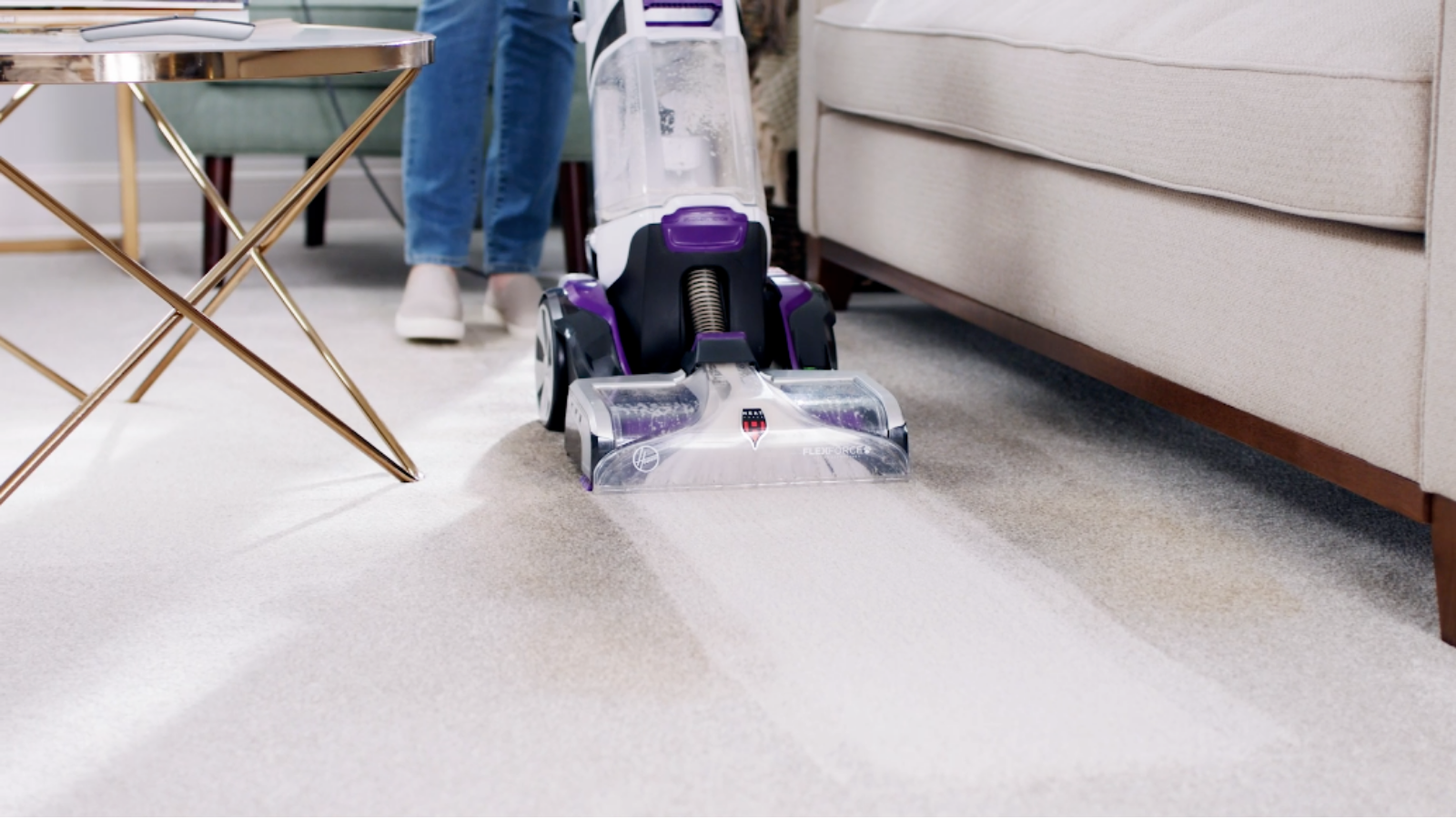 person using hoover smart wash pet to clean carpet