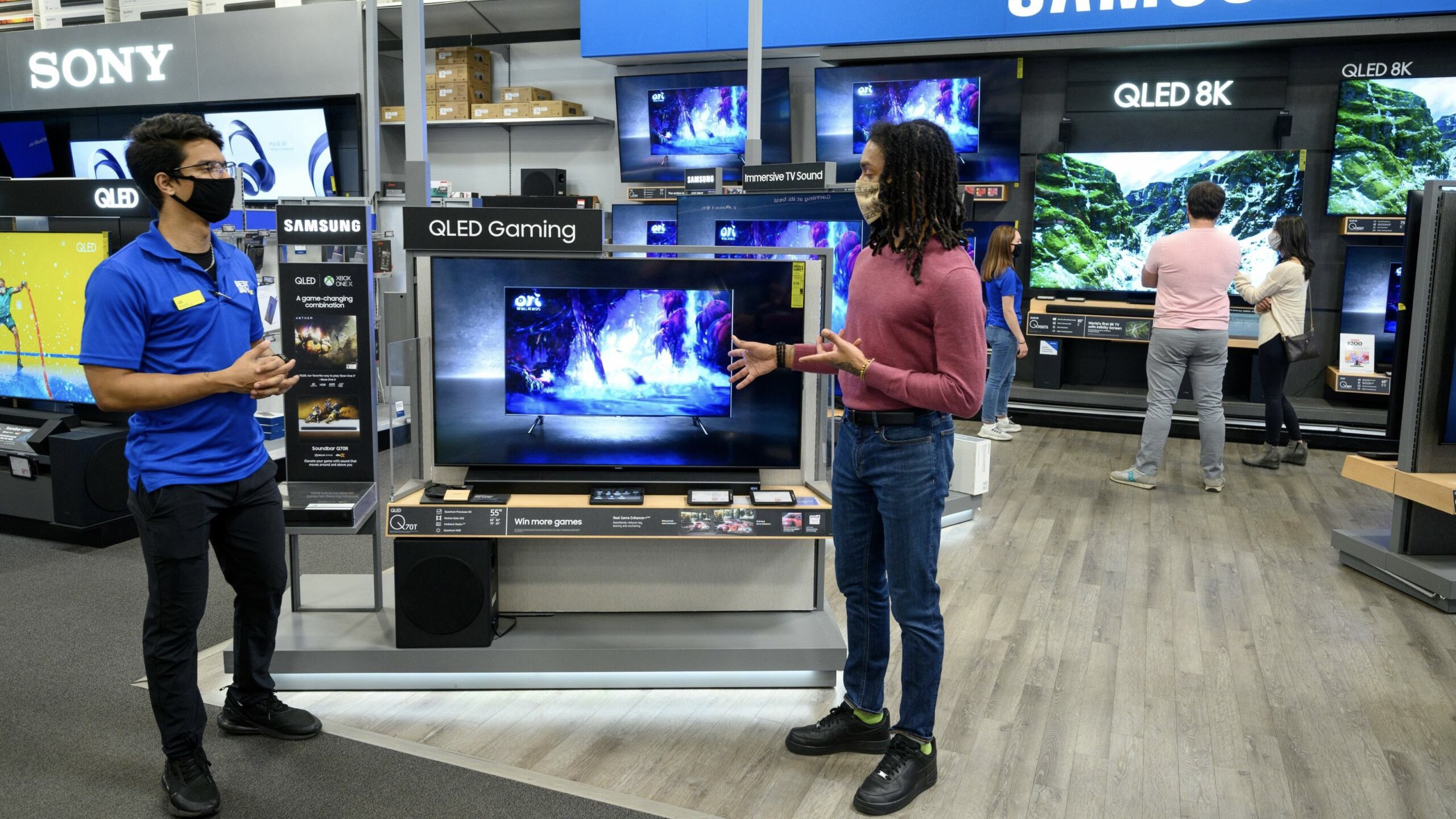 two people talking in best buy tv section