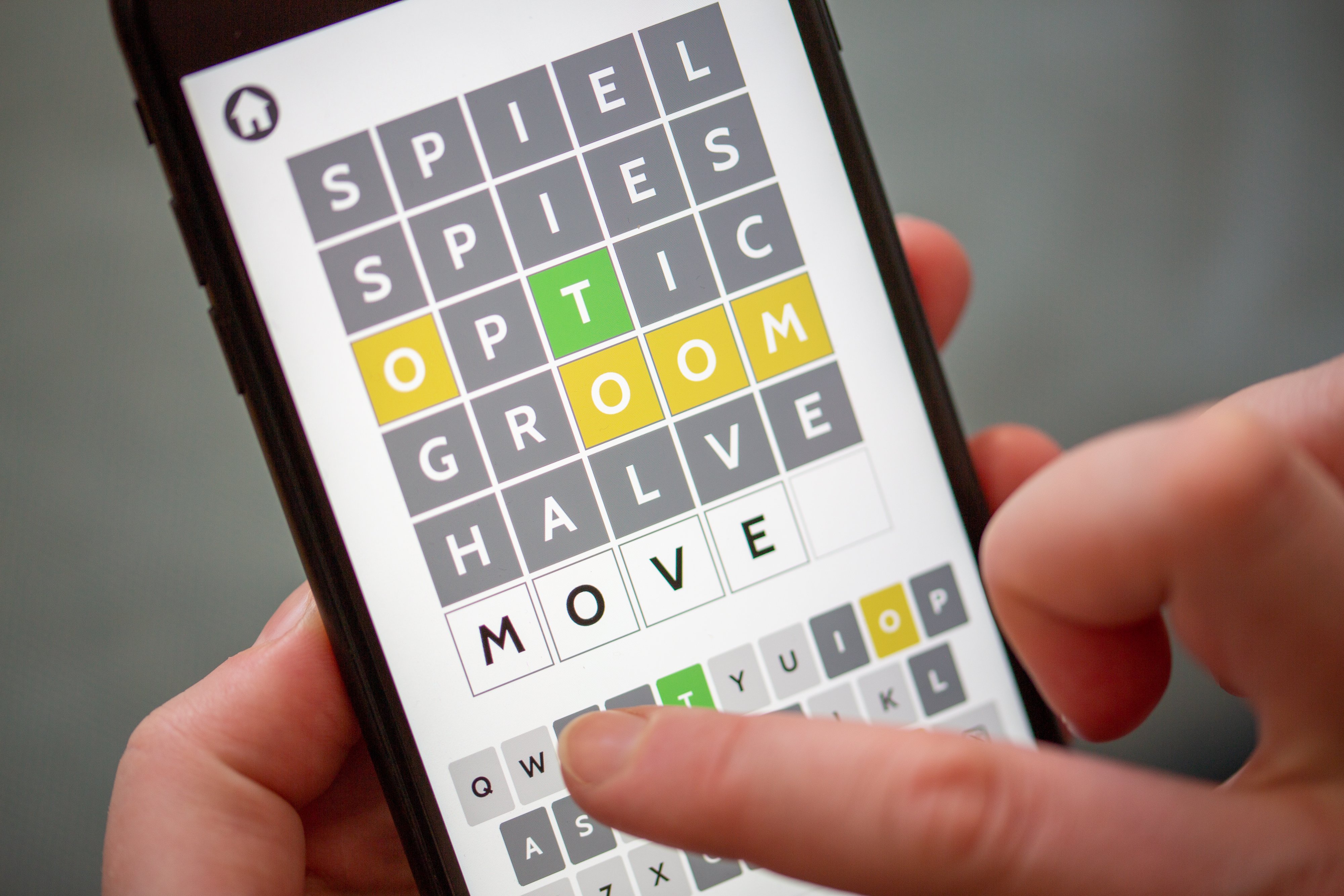 A person plays with the app of an online word game. 