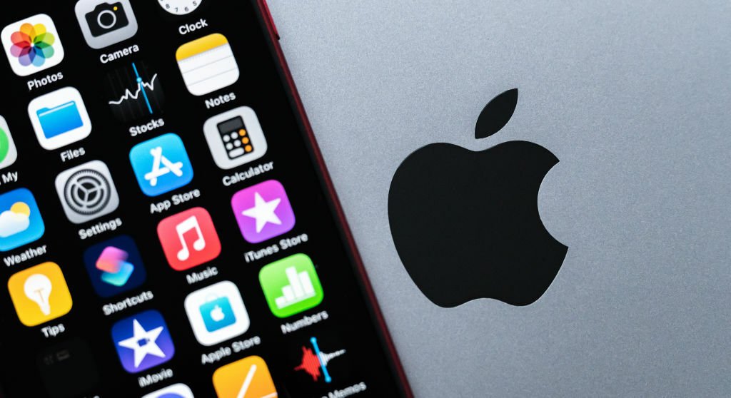 iPhone SE sitting next to Apple logo
