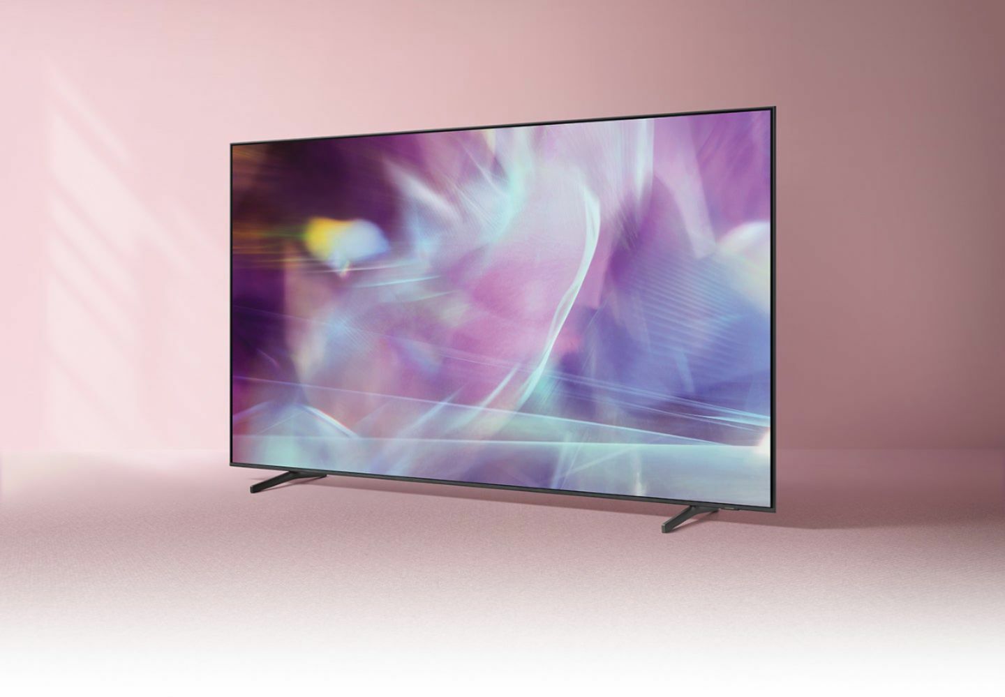 Samsung QLED TV with pink set in the background