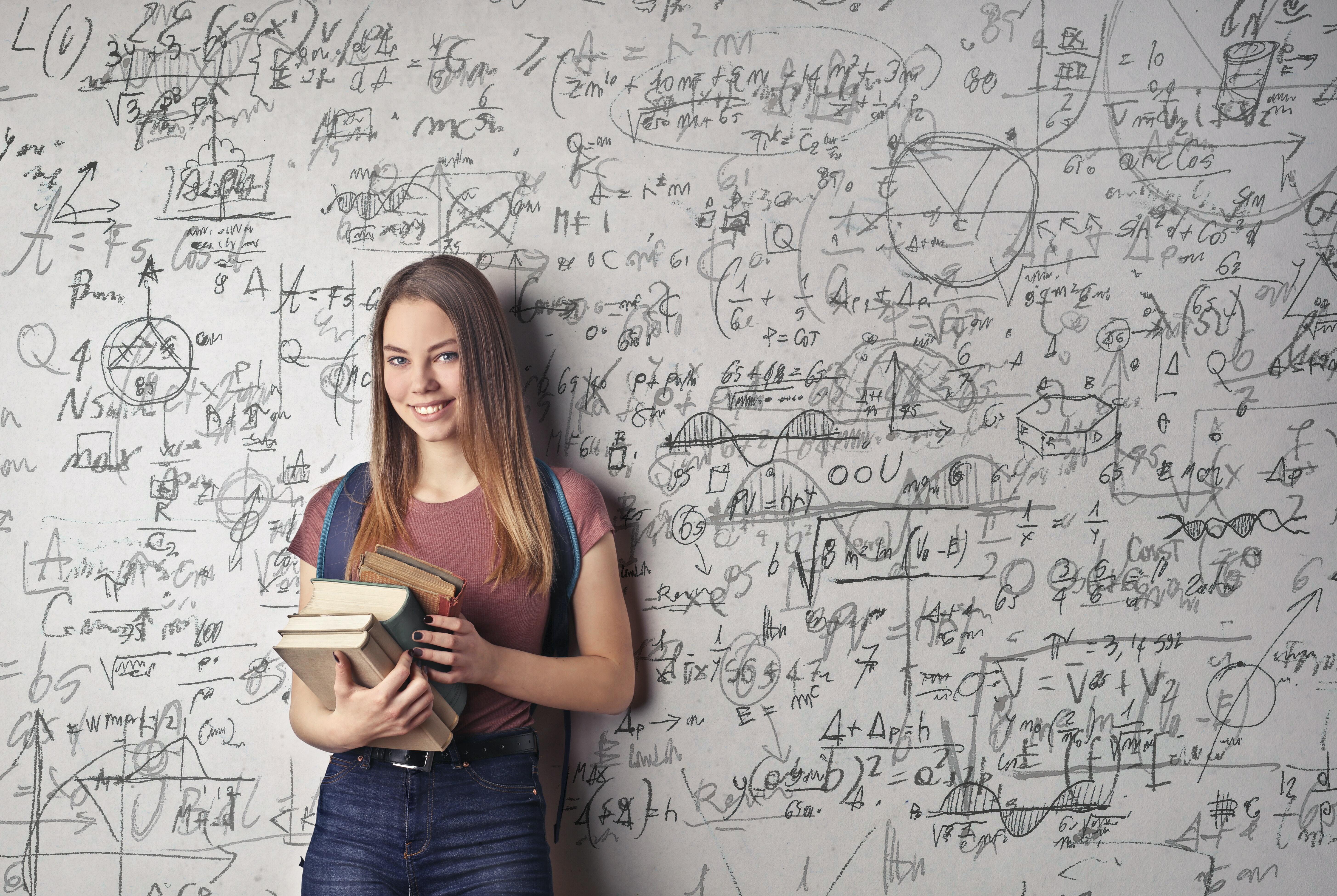 Girl standing in front of equations