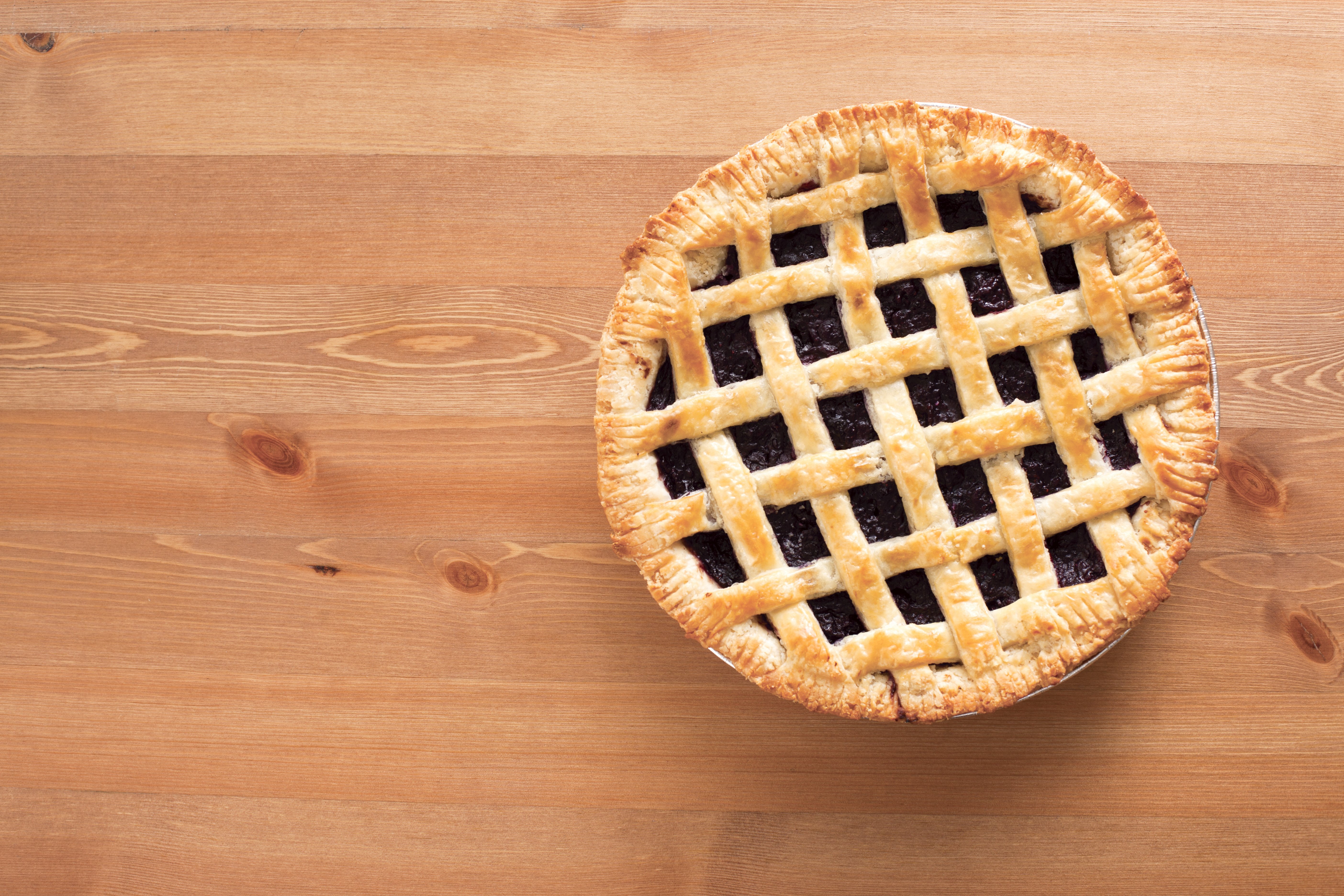 A freshly baked pie on a wooden countertop.