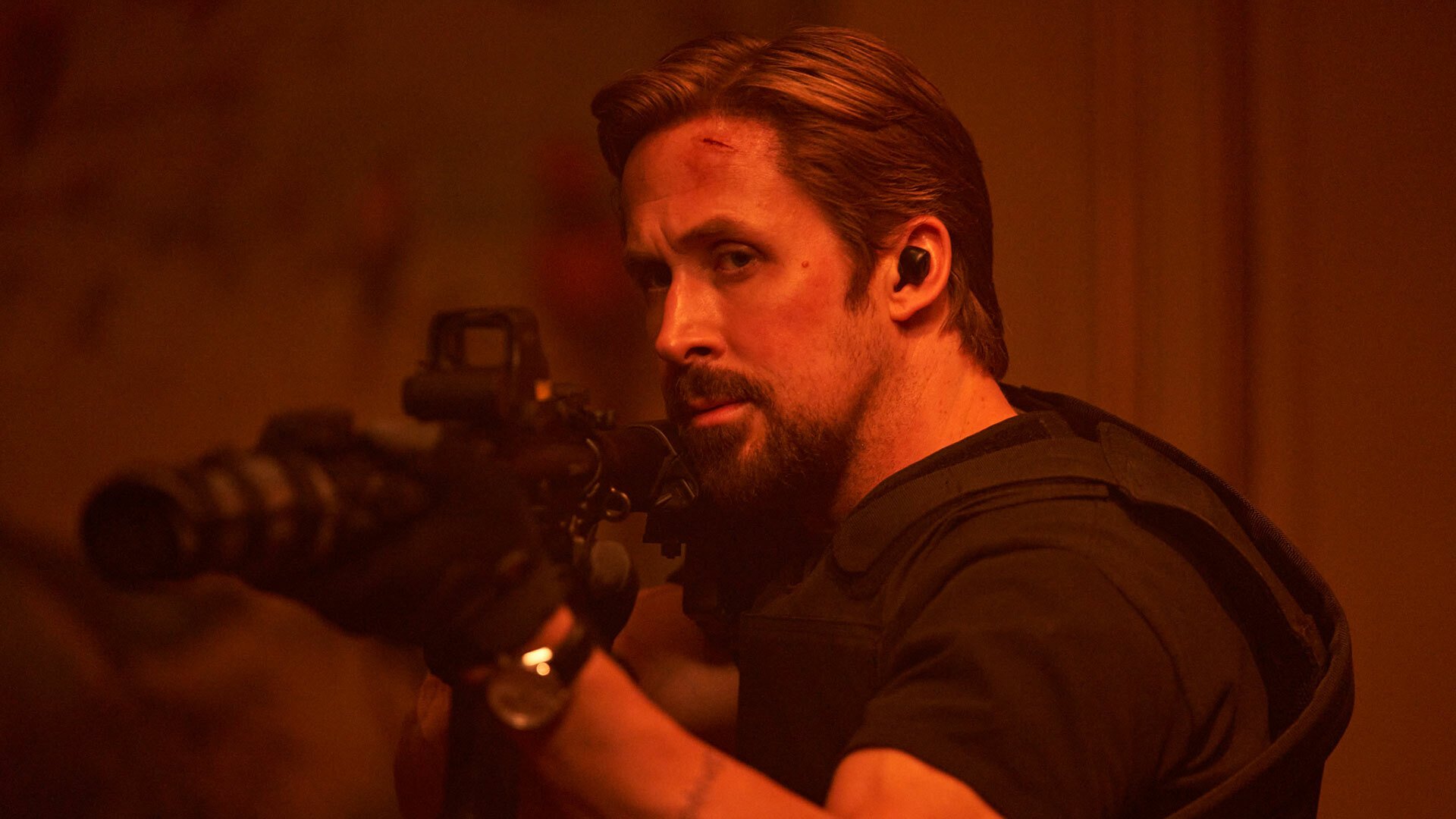 Ryan Gosling points a gun in 