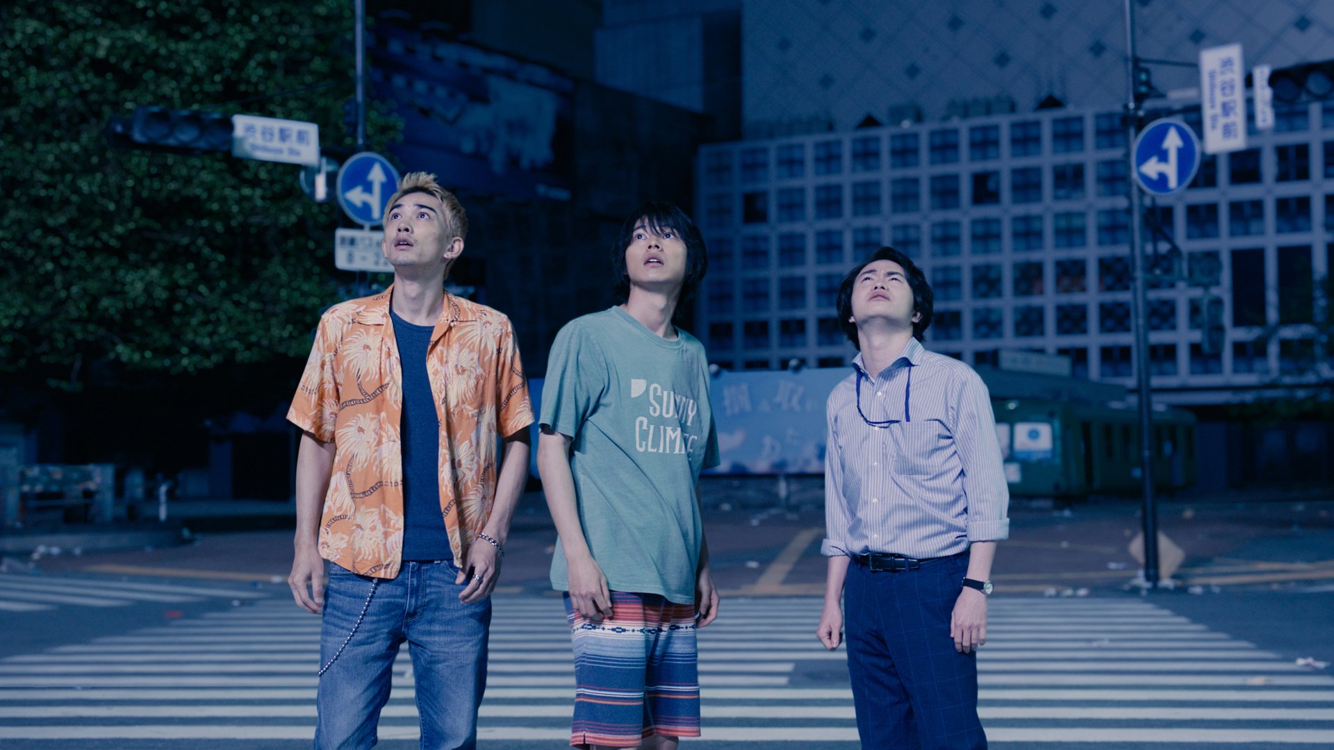 Keita Machida, Kento Yamazaki, and Yuki Morinaga stand in a very empty Shibuya Crossing in Tokyo.