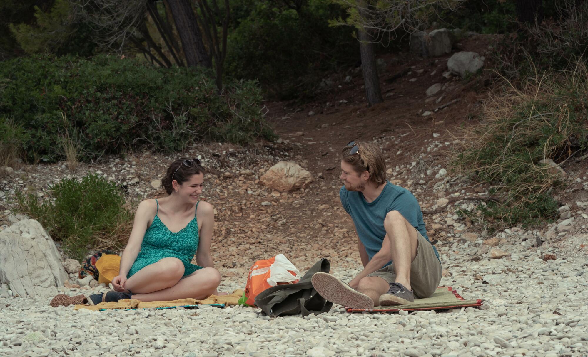 Frances and Nick talk on the beach in Croatia.