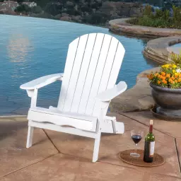 White patio chair by pool next to tray with glass and bottle of wine
