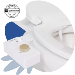 White bidet with gold knob attached to toilet