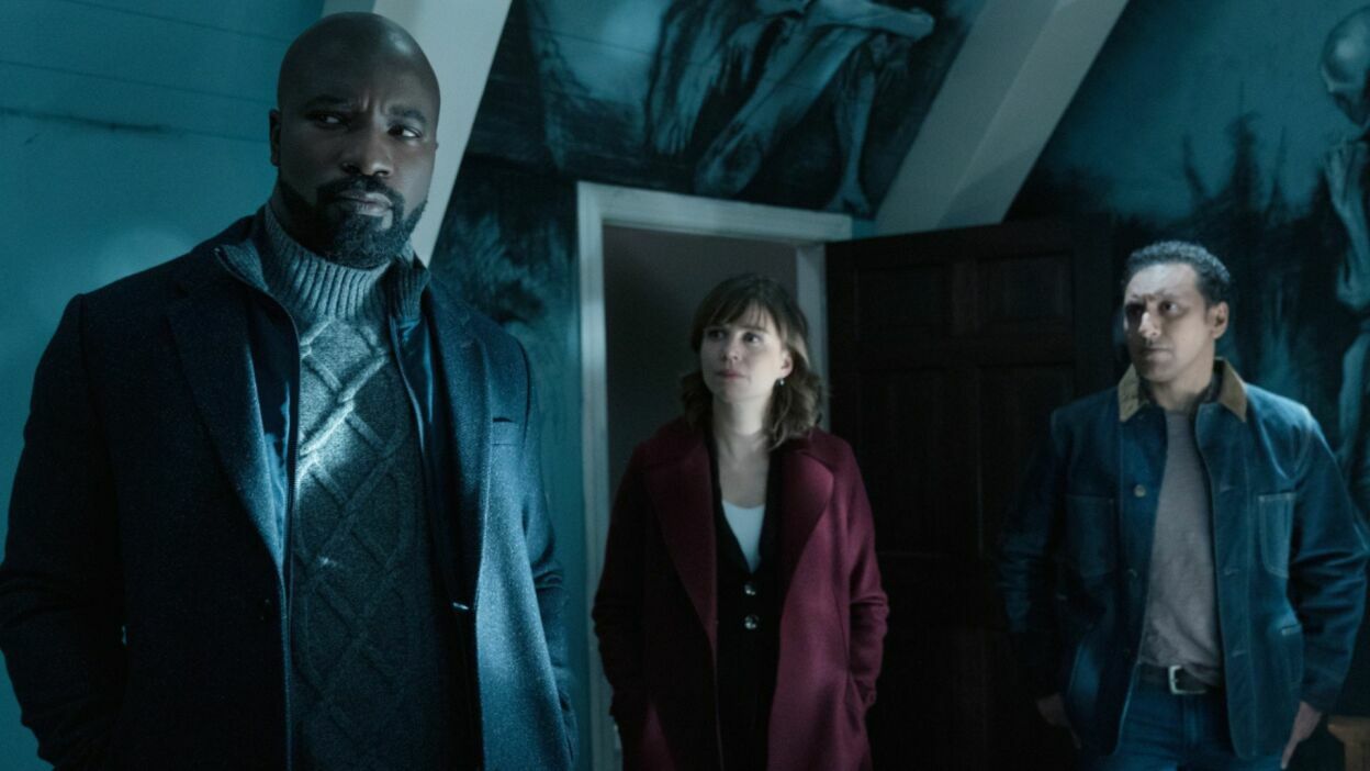 Three people in jackets investigating a room.