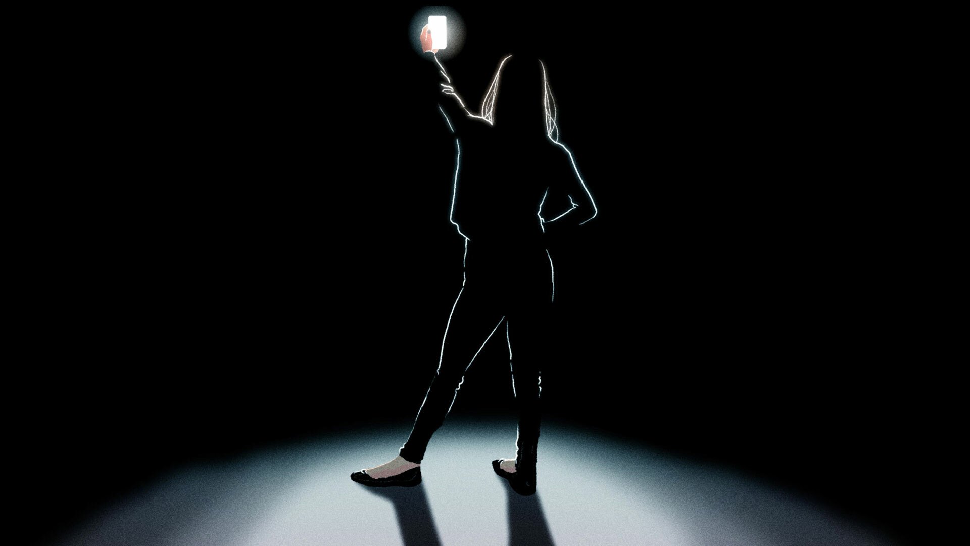 A woman taking a selfie in a dark room.
