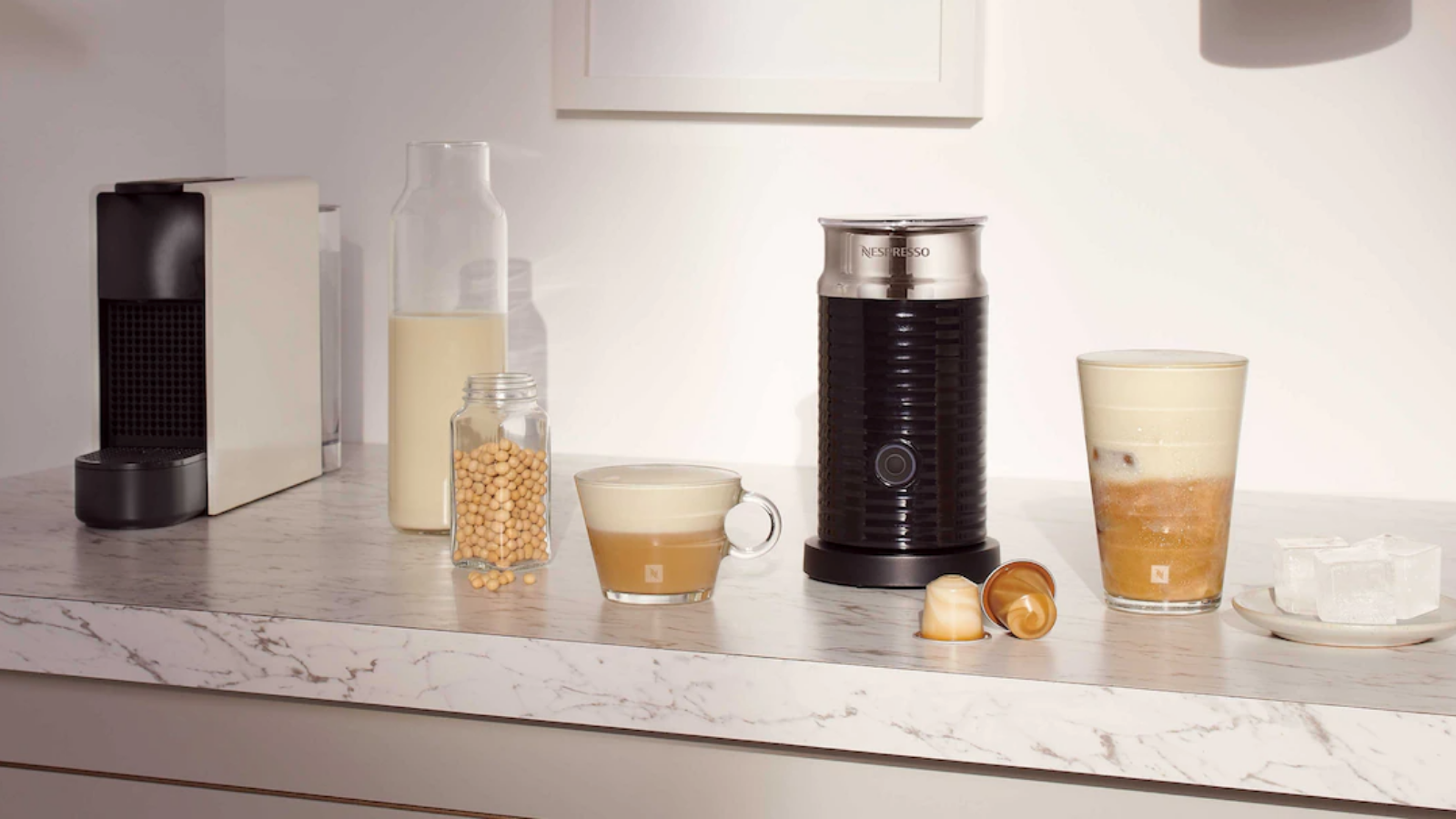 Nespresso Aeroccino3 Milk Frother with coffee maker and frothy coffee