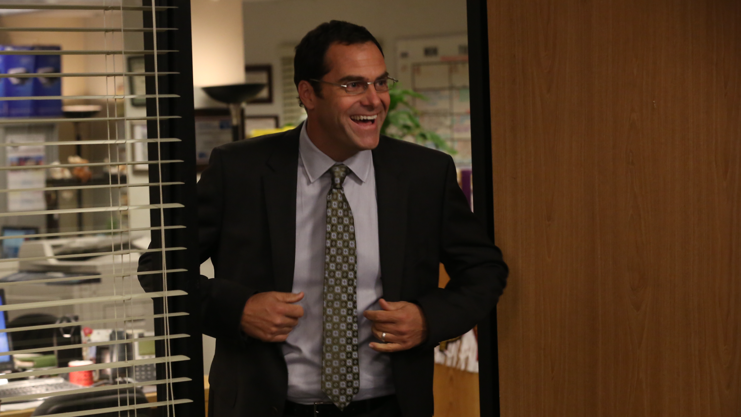 David Wallace, Dunder Mifflin's CFO, walking into the conference room