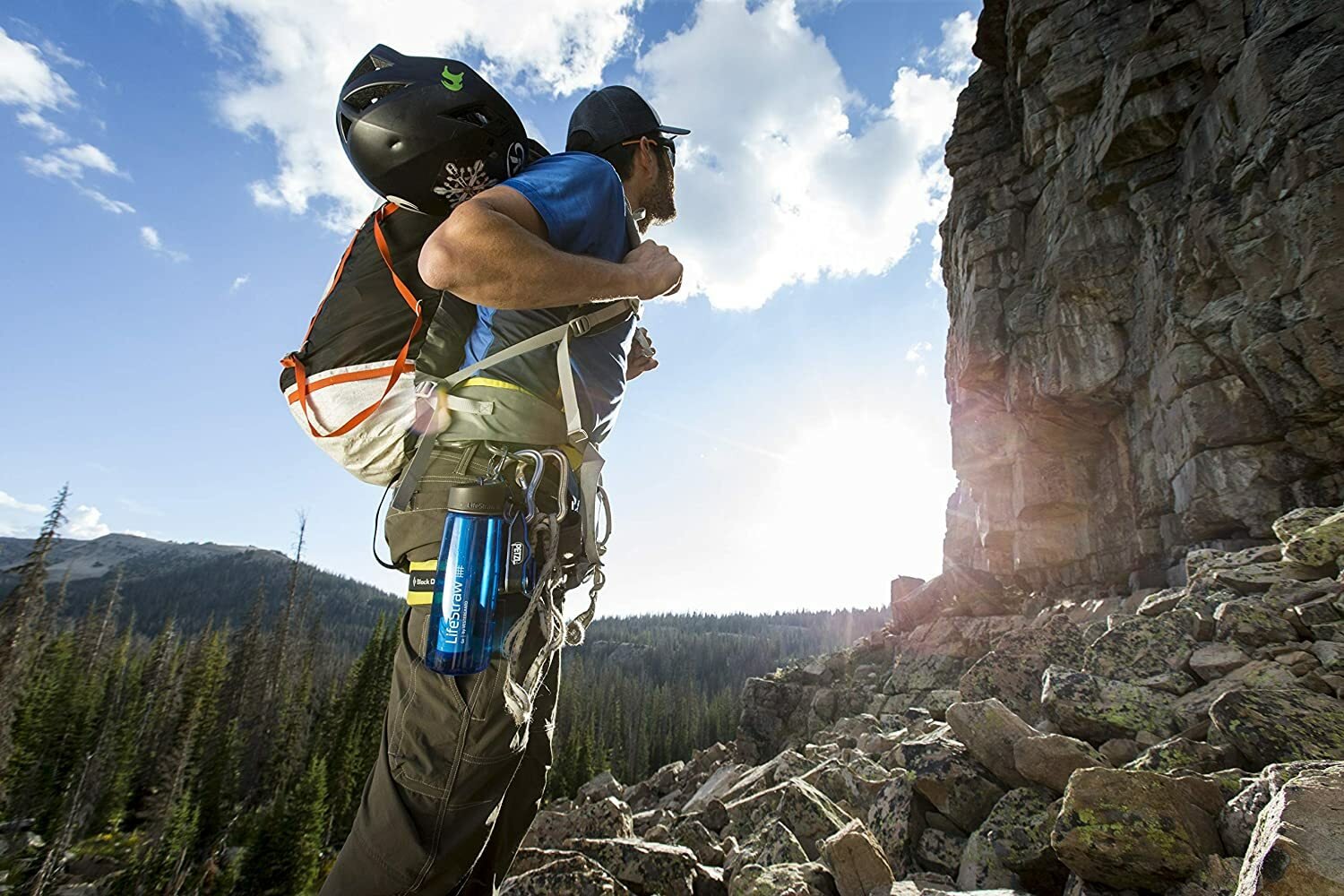 Man on mountain with lifestraw water bottle