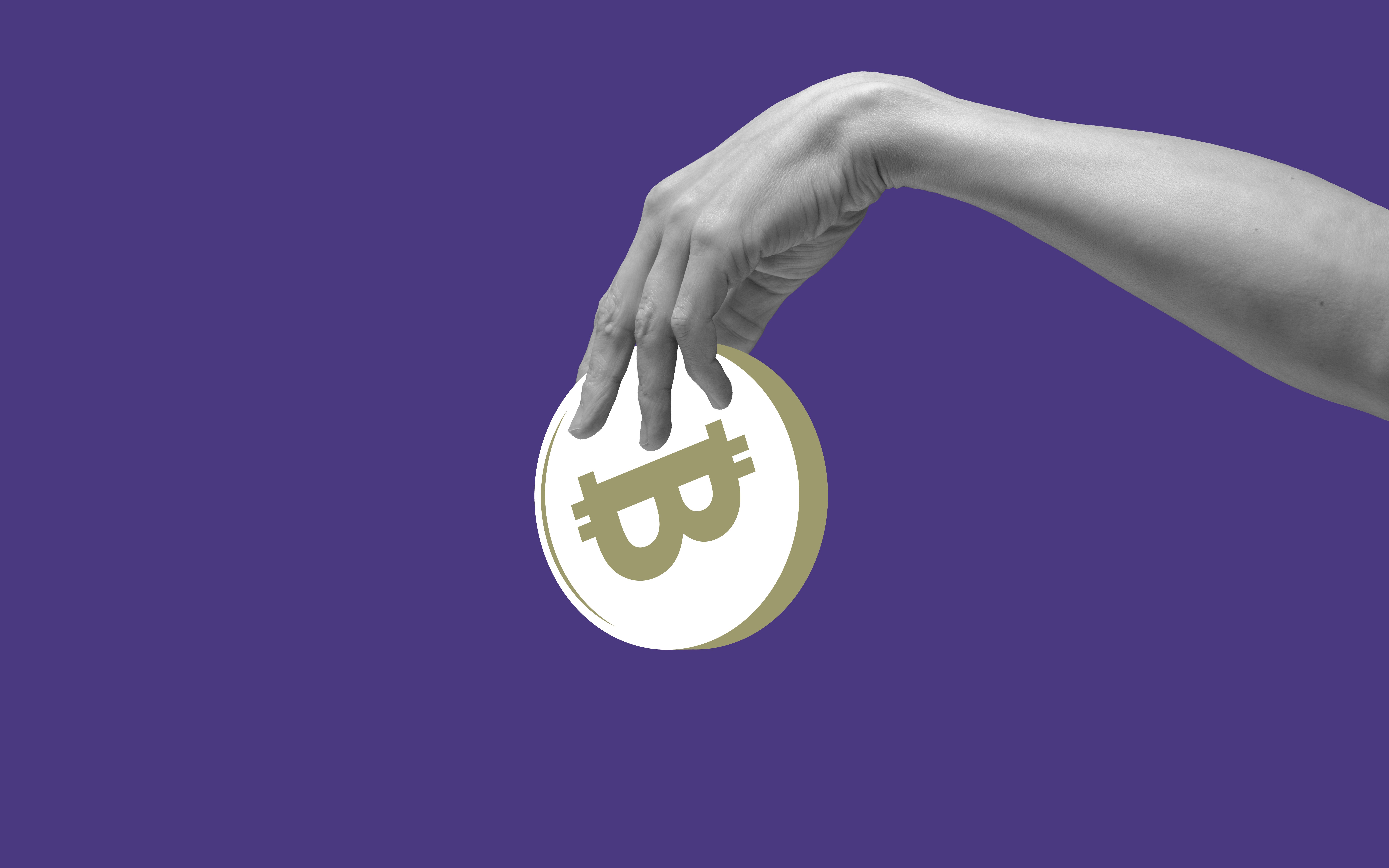 Hand holding abstract bitcoin against purple background.