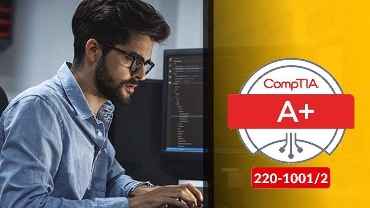 Person looking at computer screen next to a+ certification
