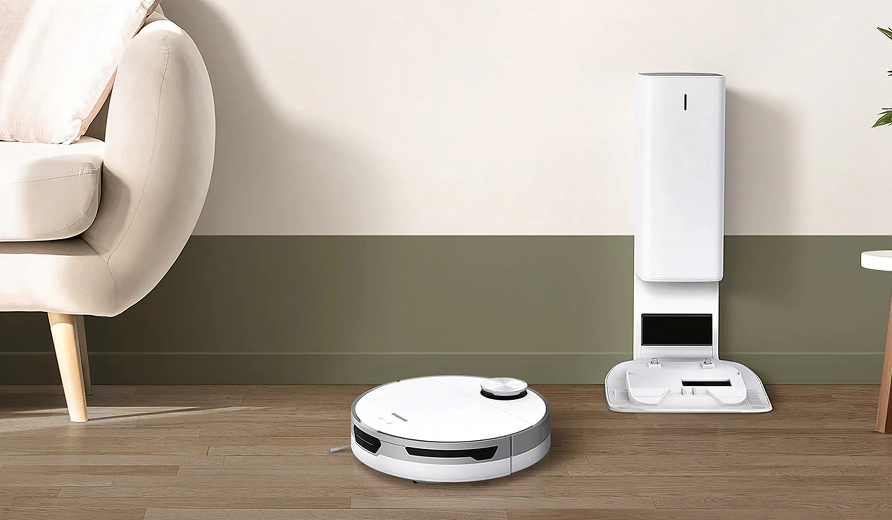Samsung robot vacuum and dock on hardwood floor with couch in corner