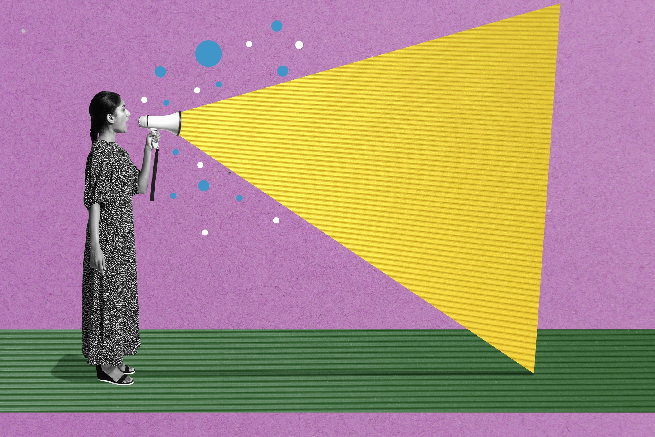 A woman talks into a megaphone 
