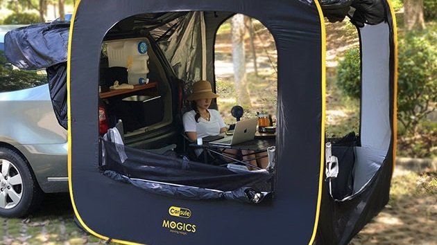 Person using the CARSULE Pop-Up Cabin for Your Car.