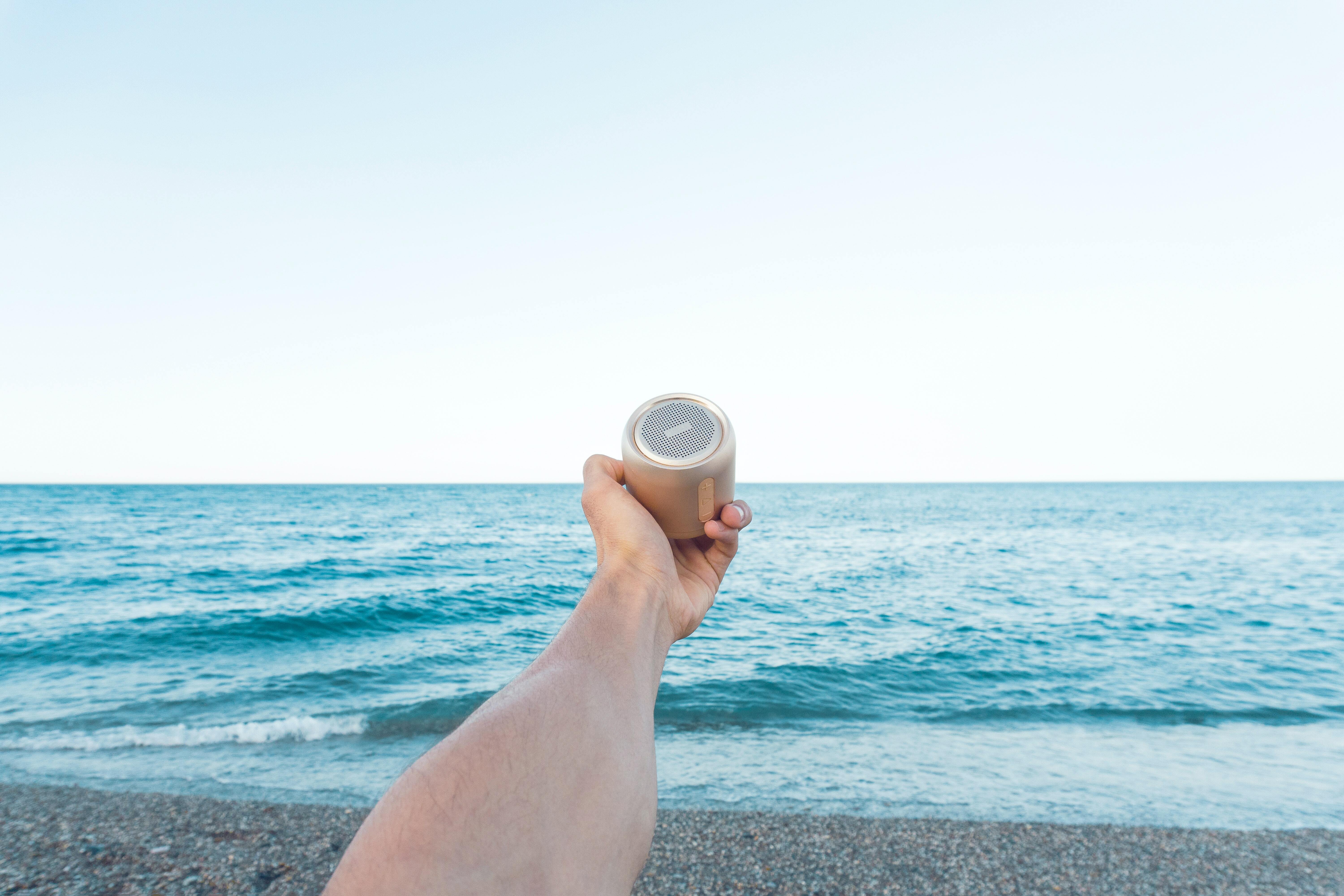 Speaker held in front of sea
