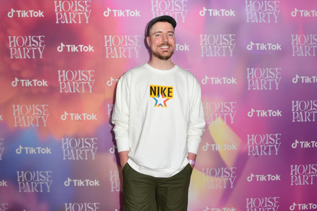 Jimmy Donaldson stands in front of a multicolored background.