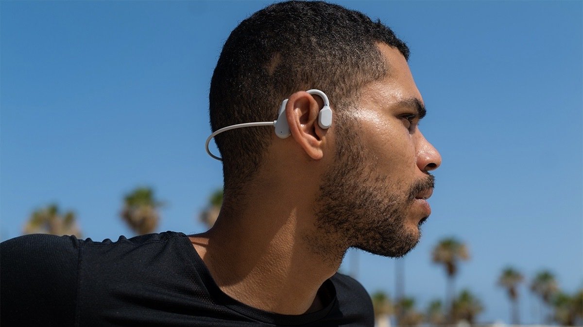 Person wearing a pair of Exobone Open-Ear Conduction Headphones.