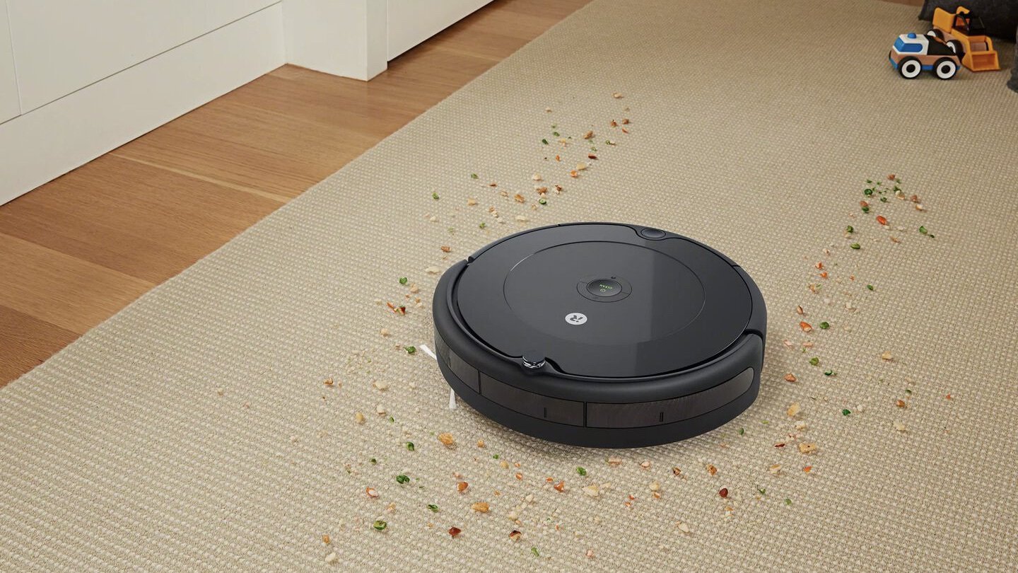 the roomba 692 cleans a mess on a rug
