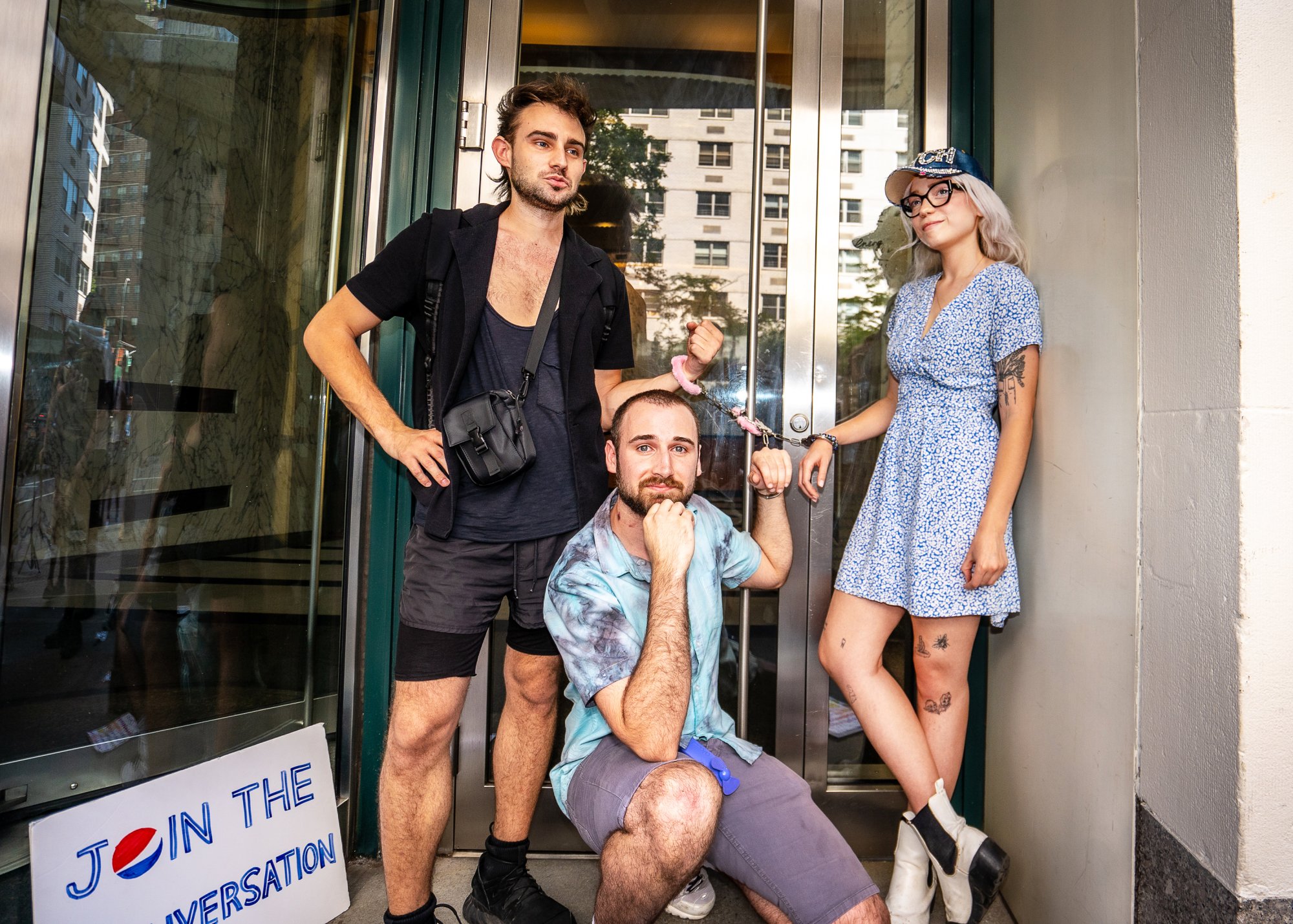 Three protesters handcuffed to the door of the New York Instagram headquarters.