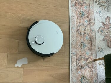 Ecovacs robot vacuum and puddle of milk on floor