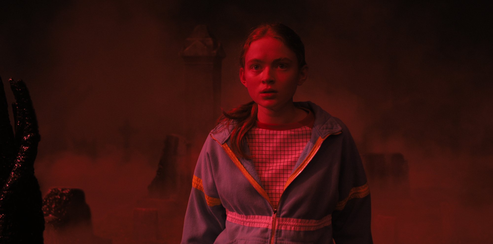 A girl bathed in red light.