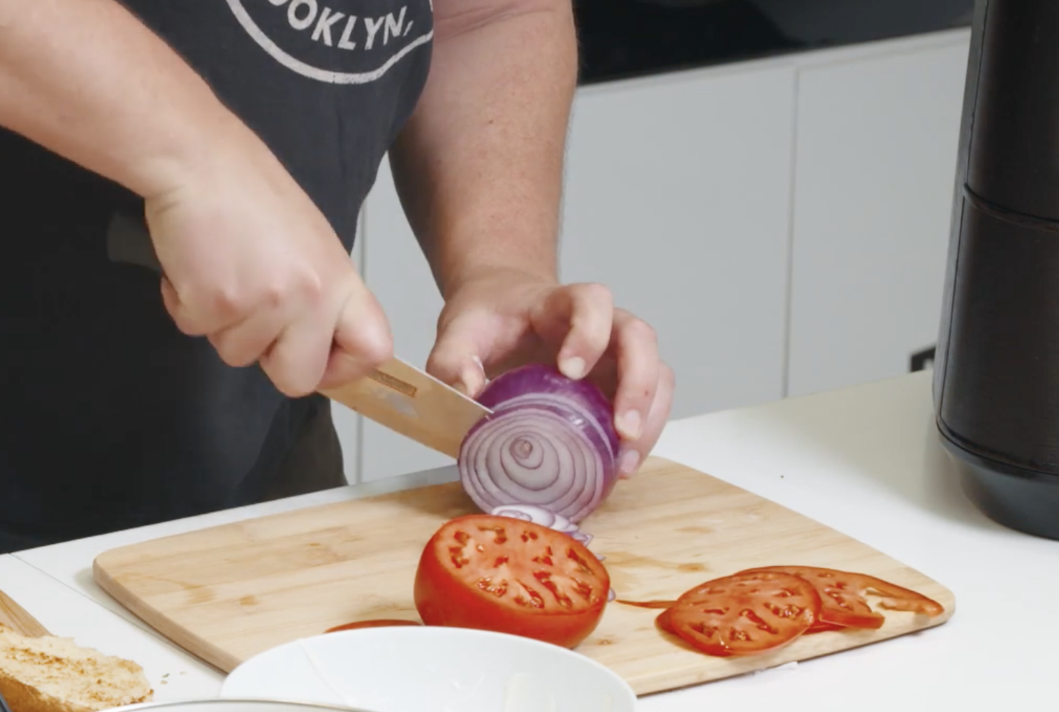 hands with knife cutting onions