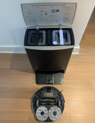 Deebot X1 Omni upside down with mopping pads and dock with lid open