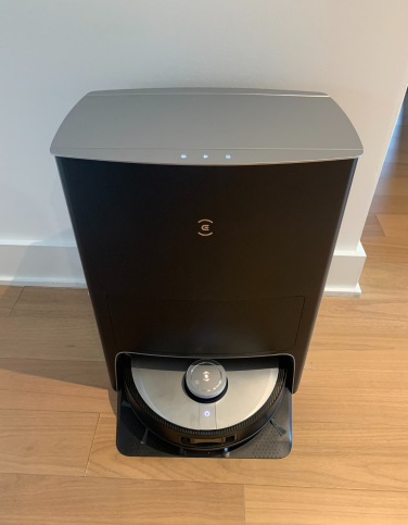 Deebot X1 Omni robot vacuum and auto-empty dock on hardwood floor