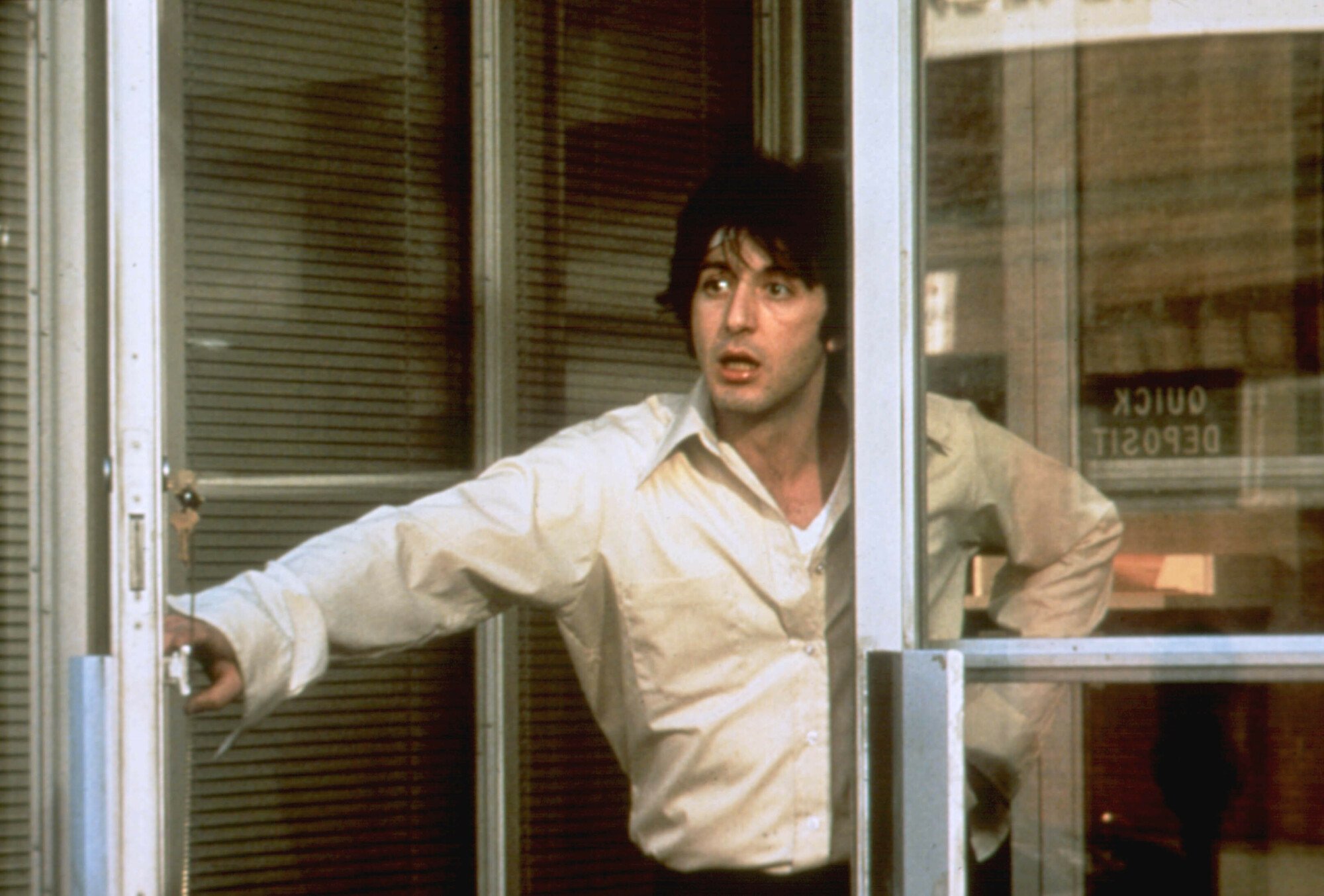 Actor Al Pacino stands in a doorway in "Dog Day Afternoon."