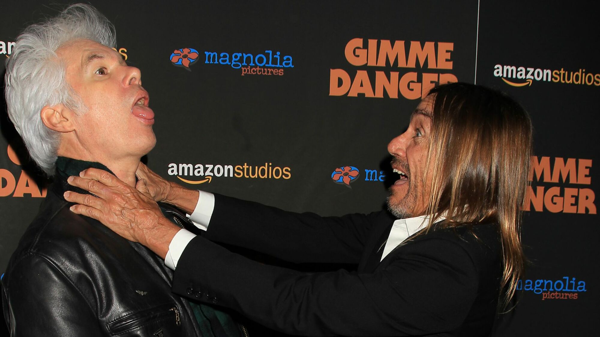 Jim Jarmusch and Iggy Pop goof around on the red carpet for "Gimme Danger."