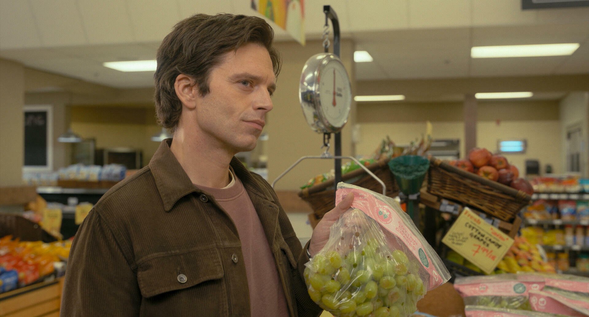 Sebastian Stan in "Fresh" holding grapes.