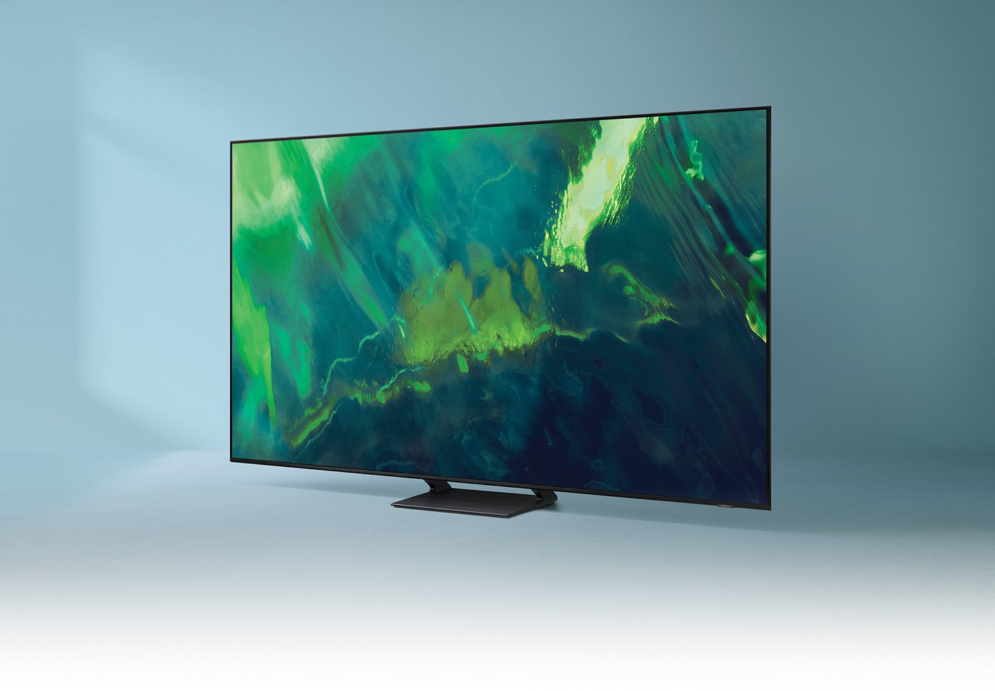 Samsung Q70A TV with green abstract screensaver on blue backdrop