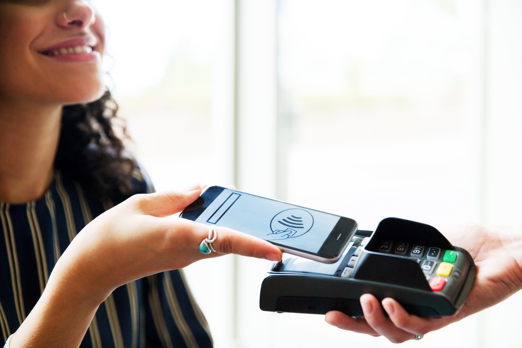 woman conducting contactless payment
