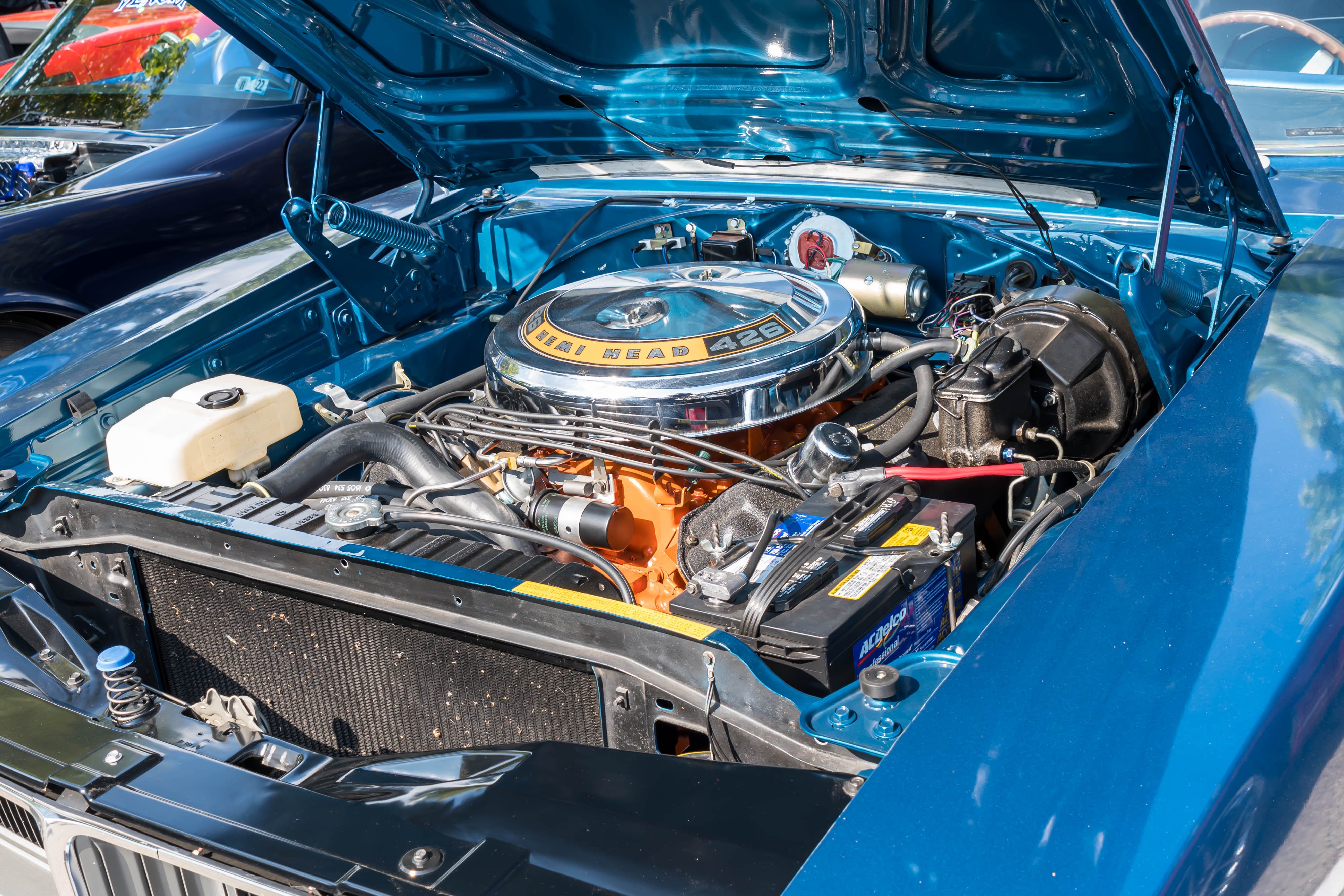 the engine compartment of a blue Dodge Charger from the 1970s