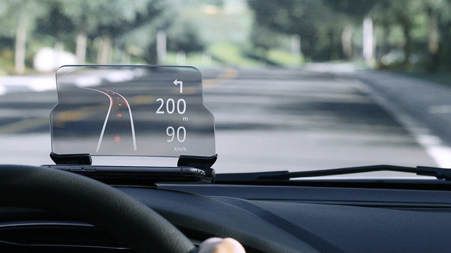 Person using the HUDWAY Glass Heads-Up Navigation Display on their dashboard.