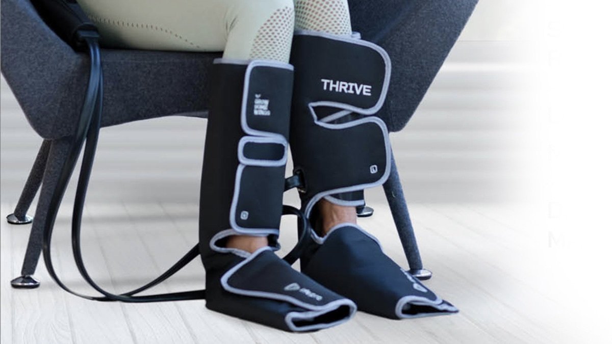 Person using the Thrive X Heat Compression Leg Massager Sleeve.