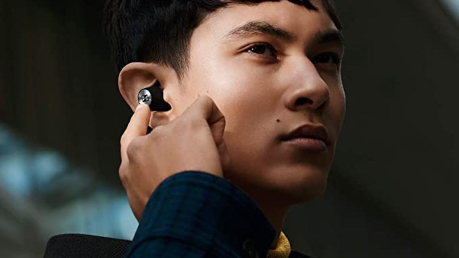 man wearing sennheiser momentum wireless 2 earbuds